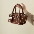 Brown faux suede handbag with ivory polka dots, faux leather handles and silver chain charm - Brown