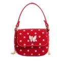 Red mini handbag with white polka dots, butterfly ornament, and gold chain shoulder strap - Red