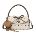 Beige polka-dot crossbody handbag with dark brown trim, bow detail and heart charms - Off White