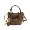 Brown leopard-print bucket tote bag with dark brown handles, shoulder strap and wooden charm. - Leopard Print