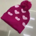 Children's knitted beanie in fuchsia with pink heart jacquard, folded cuff and matching pom-pom - One Size (3-8 Years) / Heart Rose Red