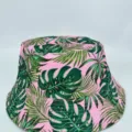 Front view highlighting the wide brim and bold green tropical leaf print on a pink fabric hat - M (56-58cm) / Pink Base Green Leaf Print Style (23)