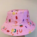 Close-up of colorful food and letter prints, including “NICE,” across a pink bucket hat. - M (56-58cm) / Pink Food Printed Style (17)