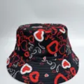 Close-up of red and white heart doodles and “love” text across the black fabric surface - M (56-58cm) / Heart Graffiti Print Style (30)