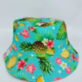 Close-up of a turquoise bucket hat with pineapple, tropical leaves, and pink and white flowers - M (56-58cm) / Green Pineapple Print Style (31)