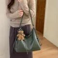 Green soft faux-leather convertible shoulder bag with adjustable strap and teddy bear charm - Green