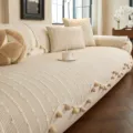 Chenille sofa cover in cream with raised bobble texture and pom-pom tassel trim, shown on a sofa - Dotted Texture (Dianxu) / 70x70cm / Khaki