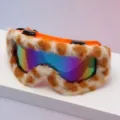Close-up of rainbow mirrored lenses framed by orange plastic and fluffy animal-print trim - Orange Frame Tiger Pattern