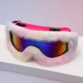 Close-up of ski goggles with a mirrored rainbow lens and fluffy white-pink trim on a pink frame - Pink Frame Pink White Gradient