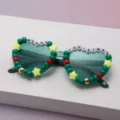Close-up of green gradient lenses framed by festive beads spelling “MERRY CHRISTMAS” - Dark Green