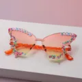 Close-up of colorful bead trim and BIRTHDAY GIRL lettering on gradient butterfly lenses - Orange to Yellow Gradient
