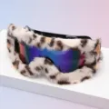 Close-up of leopard-print faux-fur trim framing iridescent mirrored lenses on snow goggles - Black Frame Leopard Edge