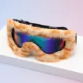 Close-up of orange and cream striped faux-fur trim around an iridescent blue-purple-green lens - Black Frame Orange Beige Stripes