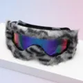 Goggles displayed on a white surface, with gray-black faux-fur trim and a blue-purple mirrored lens - Black Frame Grey Black Plush