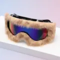 Ski goggles on a white display surface, with beige faux-fur trim and colorful mirrored lenses - Black Frame Beige Plush