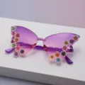 Close-up of glittery floral accents on purple butterfly sunglasses with pink-gradient lenses - Purple To Pink Gradient