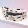 Close-up of clear goggles with white faux-fur trim, brown spots, dark lens and black clips - Clear Frame Brown Spotted Plush