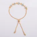 Gold-tone box chain detail with white crystal flower accents and an adjustable slider clasp - White (5327)