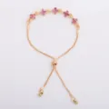 Gold-tone chain bracelet with pink flower charms, an adjustable slider clasp and bead-ended tails - Pink (5328)