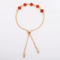 Gold-tone bracelet laid flat, featuring red crystal flower links and an adjustable sliding clasp - Four Leaf Flower Bracelet (5335) / Red