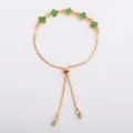 Gold-tone chain with green flower-shaped stones and sliding clasp, shown flat on white - Green