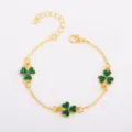 Gold-tone bracelet with three green four-leaf clover charms, lobster clasp and extender chain - Green