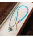 Collana di perline turchesi con dettagli perlati e ciondolo a zucca smaltato con bordo dorato - Stile Zucca Turchese Ottimizzato