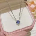 Close-up of a blue stone four-leaf pendant on a silver chain, displayed in a pink velvet jewelry box - Four-leaf Clover Pendant Style (X372) / Silver