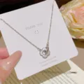 Silver-tone pendant with a mother-of-pearl four-leaf flower and LOVE ring, displayed on a card - Four-leaf Flower Pendant (X354) / Silver