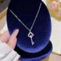 Silver-tone titanium steel necklace with a sparkling key pendant and openwork four-leaf clover - Clover Key Style (X677)