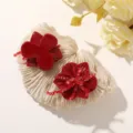 Close-up of two red resin flower hair accessories, including a claw clip and a beaded floral piece - Red Six-Petal Flower