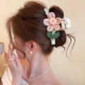 Side view of a woman wearing a white lace-textured hair clip with a pink flower and green leaves - Approx 13cm / Single Flower Pink Lace Bow (13cm)