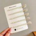 Set of five beige metal duckbill hair clips with perforated design, displayed on a white card - 5 Pieces/Pack / Beige