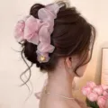 Large pink chiffon flower claw clip with a gold heart charm, worn in a low bun hairstyle - Approx 13cm / Pink Mesh Pleated Cloud Heart (13cm)