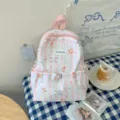 Sac à dos rose pour enfant, à rayures pastel, motif cupcake et cerises, avec poche avant à cordon - Gâteau aux cerises