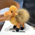 Plush camel charm displayed with a shaggy tan tail, black feet and a metal hanging hook - Golden Khaki
