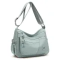 Sac en nylon vert sauge clair, à bandoulière réglable et poches zippées superposées. - Bleu ciel