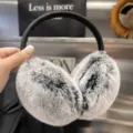 Close-up of gray-white plush earmuffs with black markings and a black flexible headband - Frosted Black