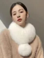 White fluffy faux-fur neck warmer with a round pom-pom, worn as a cozy winter accessory - Cream