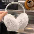 Light gray plush winter earmuffs with a soft curved headband, held up to show their shape - Light Gray