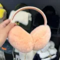 Pink plush winter earmuffs with soft fur-covered cups and a flexible matching headband for warmth - Pink