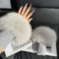 Gray wrist warmers with fluffy fur trim and ribbed knit cuffs, shown worn and laid flat - Light Gray