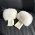White fluffy wrist warmers with pom-pom fur tops and cream knitted cuffs, shown as a pair - Off White