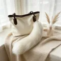White fluffy fox-tail bag charm with a long plush tail, shown hanging from a beige tote - White Fox Tail