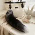 Fox-tail bag charm in black and silver-gray fur, with a gold-tone hook and chain for bags - Black Fox Tail