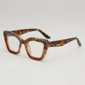 Lunettes œil-de-chat en écaille léopard, verres bleu clair et branches ornées de rivets - Monture Écaille Verre Blanc
