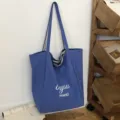 Bolso tote azul de lona, con asas de rayas y letras blancas “thank you merci” en la parte frontal - 46*14*37 / Azul cielo