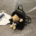 Black suede mini backpack with faux-leather trim and a brown plush teddy bear charm - 15*7*21 / Black