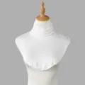 Close-up of a white knit dickey with a delicate lace-trimmed neckline on a display bust - Tops / White