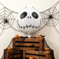 Halloween scene with a white skull foil balloon, spiderwebs, spiders and orange pumpkins - 18 Inch Skull Foil Balloon / 2 Pieces Pack
